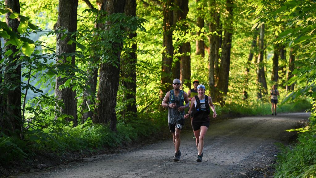 Amy guiding a visually impaired runner during the Vermont 100 